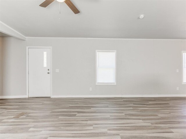 empty room with crown molding and light hardwood / wood-style floors