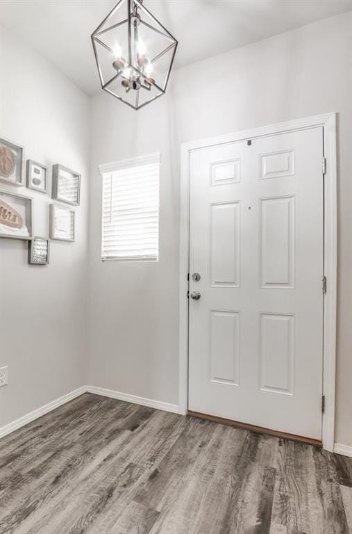 foyer entrance with a chandelier and hardwood / wood-style flooring