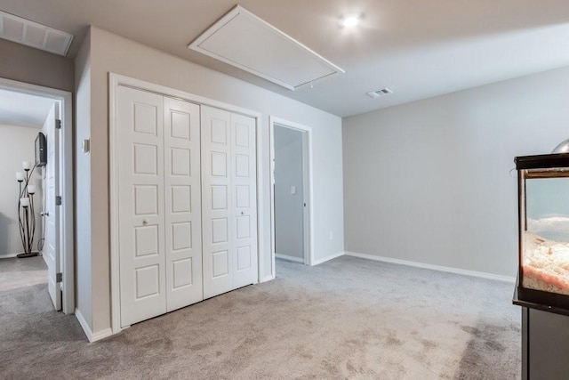 unfurnished bedroom featuring light carpet and a closet