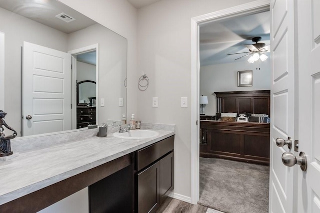 bathroom with ceiling fan, vanity, and hardwood / wood-style flooring