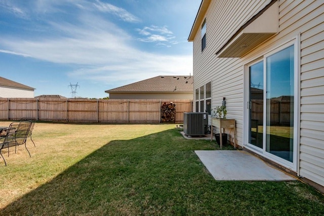 view of yard featuring central AC and a patio