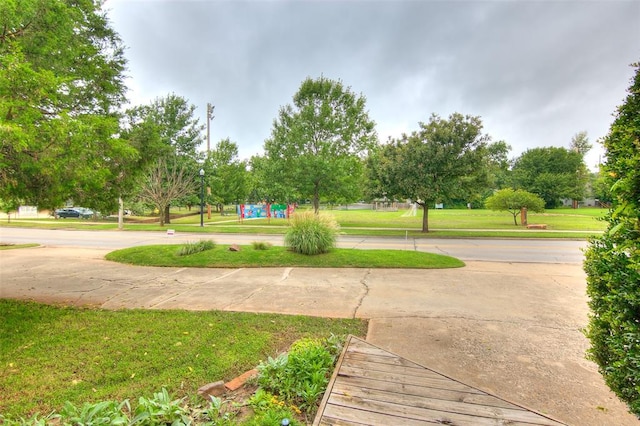 view of property's community with a lawn