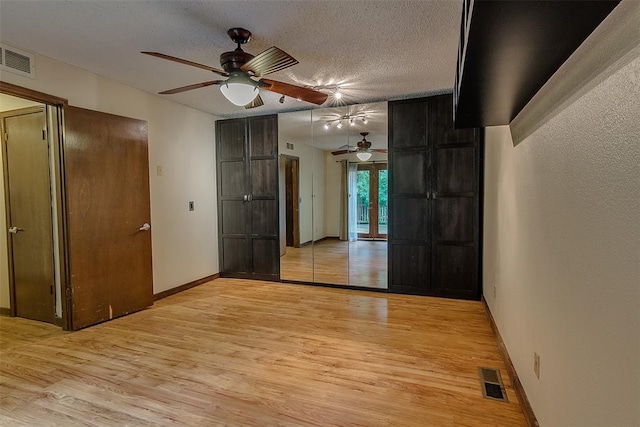 interior space with light hardwood / wood-style floors and a textured ceiling