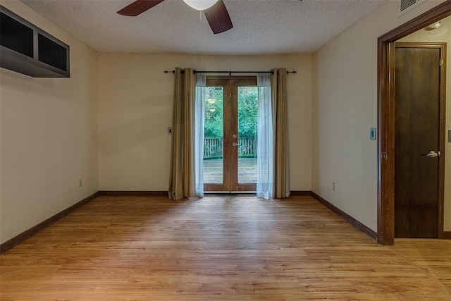 unfurnished room featuring ceiling fan, a textured ceiling, and light wood-type flooring