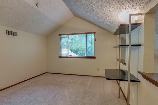 bonus room with a textured ceiling, light carpet, and vaulted ceiling