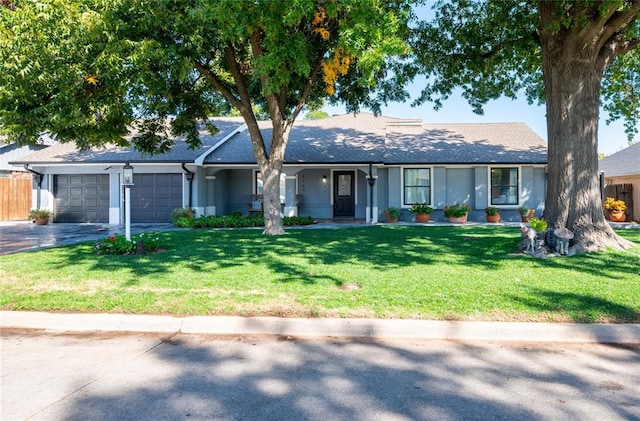 ranch-style house featuring a front yard and a garage