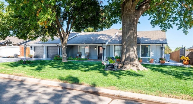 single story home featuring a garage and a front lawn