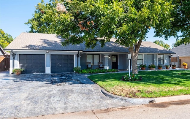 single story home with a front yard and a garage