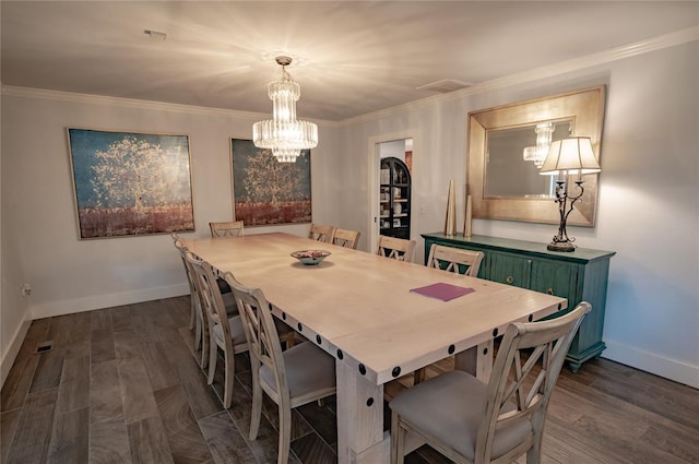 dining space featuring a notable chandelier, dark hardwood / wood-style floors, and crown molding