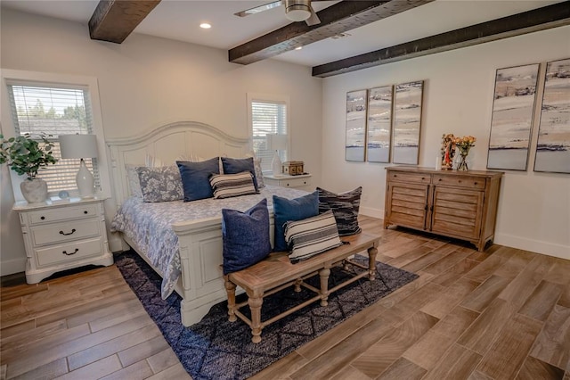 bedroom with beamed ceiling, light hardwood / wood-style floors, multiple windows, and ceiling fan