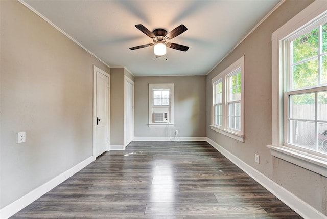 empty room featuring dark hardwood / wood-style flooring, ceiling fan, and a healthy amount of sunlight