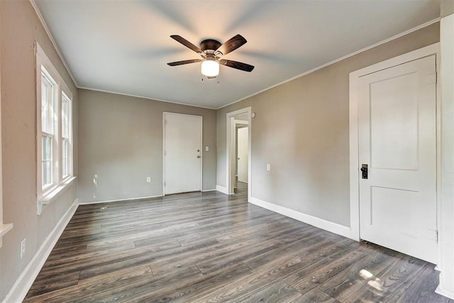 empty room with dark hardwood / wood-style floors, ceiling fan, and ornamental molding