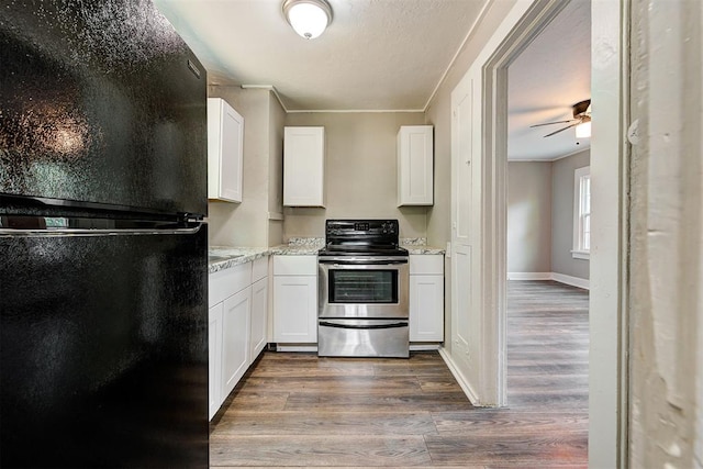 kitchen featuring stainless steel electric range, white cabinets, black fridge, ceiling fan, and dark hardwood / wood-style flooring