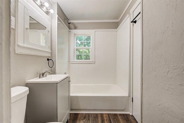 full bathroom featuring hardwood / wood-style flooring, vanity, toilet, and bathtub / shower combination