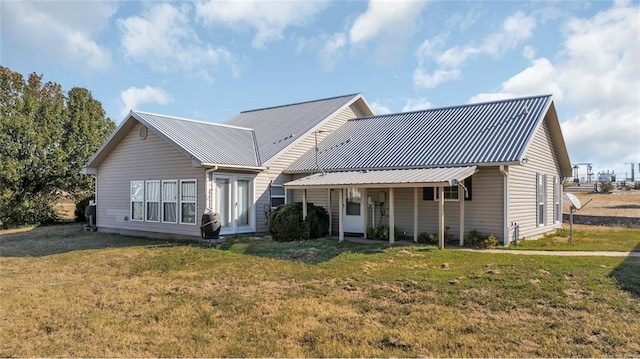 rear view of property featuring a yard