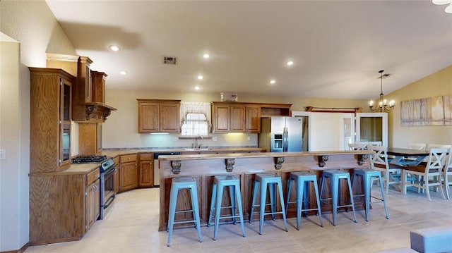 kitchen featuring a kitchen island, a chandelier, and appliances with stainless steel finishes