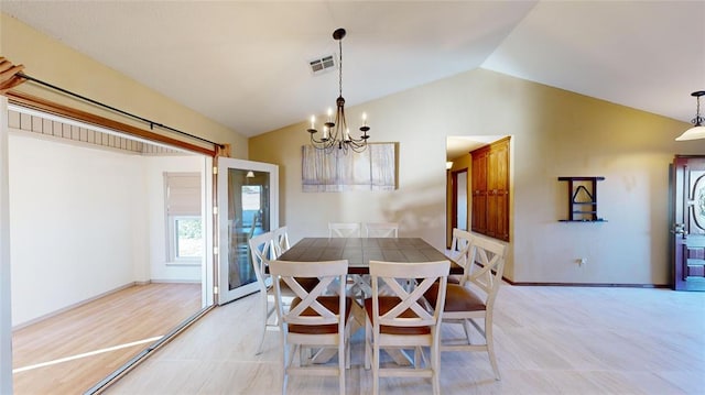 dining room with vaulted ceiling and a notable chandelier