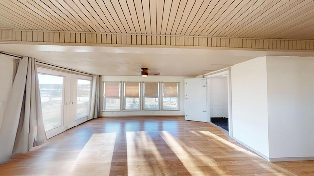 unfurnished living room with french doors, light hardwood / wood-style flooring, and wooden ceiling