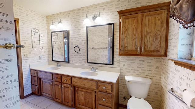 bathroom featuring tile patterned flooring, vanity, and toilet