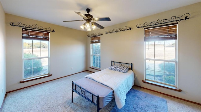 bedroom with multiple windows, carpet, and ceiling fan