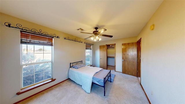 bedroom with ceiling fan and light colored carpet