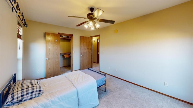 carpeted bedroom featuring ceiling fan and a closet