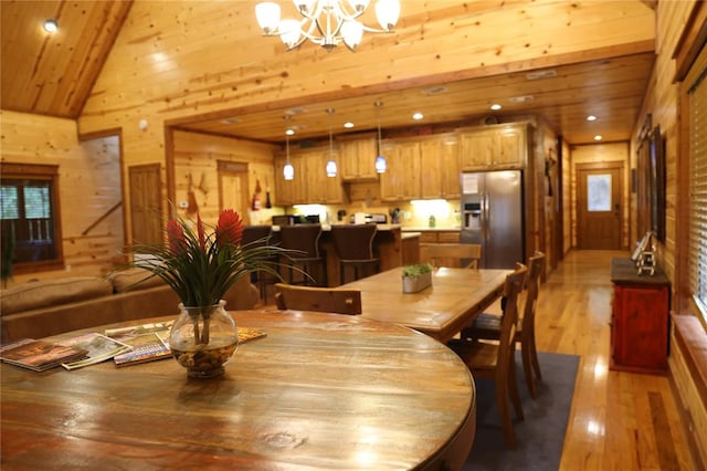 dining area with a chandelier, high vaulted ceiling, light hardwood / wood-style flooring, and wood ceiling