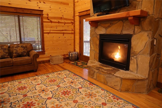 living room featuring hardwood / wood-style flooring, plenty of natural light, and wooden walls