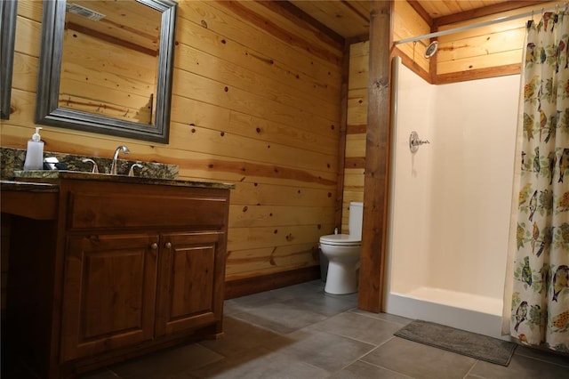 bathroom featuring tile patterned floors, a shower with curtain, wooden walls, and vanity