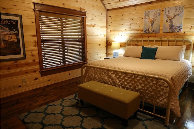 bedroom featuring wooden walls, dark wood-type flooring, and vaulted ceiling