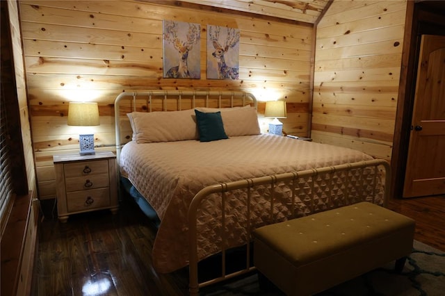 bedroom featuring wooden walls, dark hardwood / wood-style flooring, and lofted ceiling