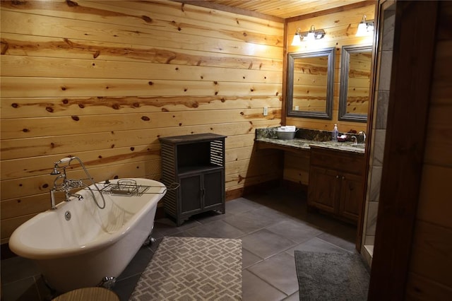 bathroom with wooden walls, a washtub, vanity, and tile patterned flooring