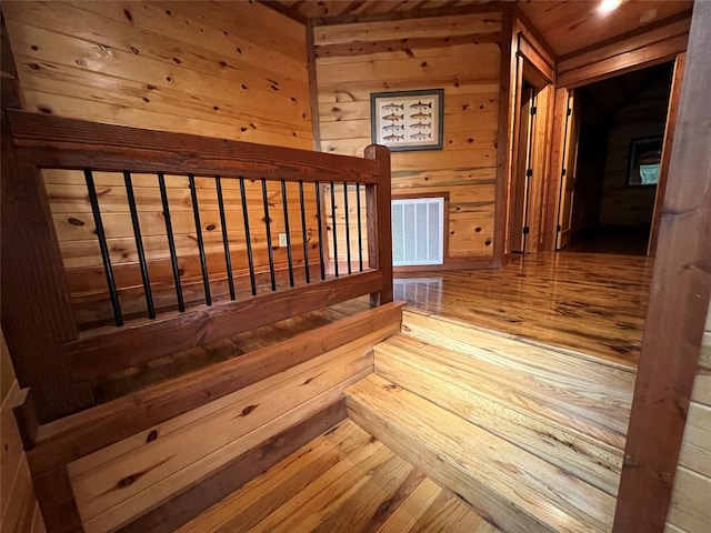 interior space with wood walls and wood-type flooring