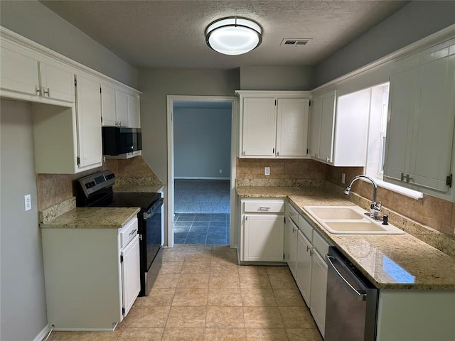 kitchen featuring backsplash, white cabinetry, sink, and appliances with stainless steel finishes