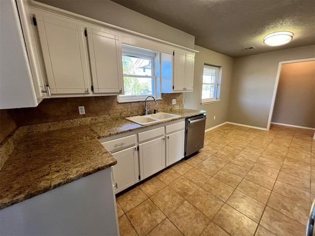 kitchen featuring decorative backsplash, stainless steel dishwasher, a textured ceiling, sink, and white cabinetry