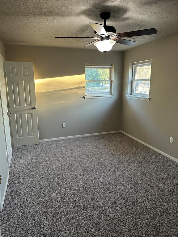 unfurnished room featuring carpet, ceiling fan, and a textured ceiling