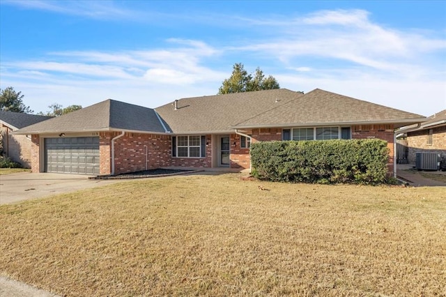 ranch-style home with a front lawn, cooling unit, and a garage