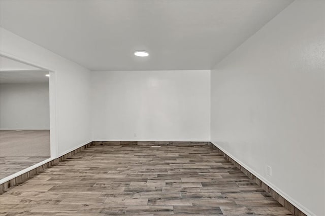 spare room with wood-type flooring