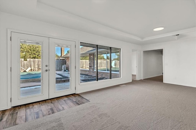 empty room featuring french doors and hardwood / wood-style floors