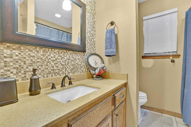 bathroom with tile patterned flooring, vanity, tasteful backsplash, and toilet