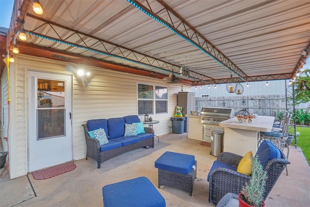 view of patio / terrace with an outdoor hangout area, a grill, and exterior kitchen