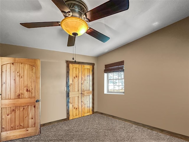 unfurnished bedroom featuring carpet, ceiling fan, and baseboards