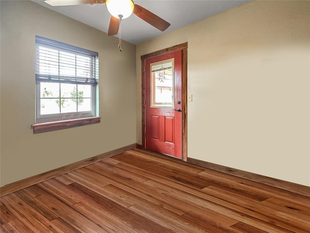 foyer featuring a ceiling fan, baseboards, and wood finished floors