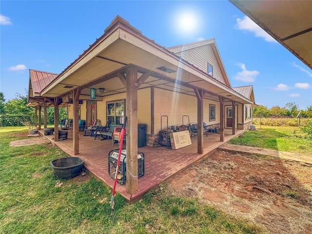 exterior space with a deck, metal roof, and a yard