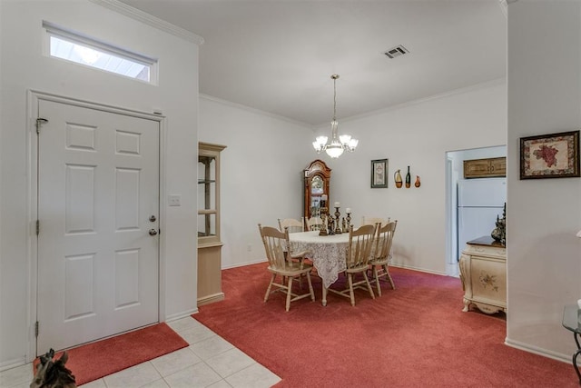 carpeted dining space with a chandelier and ornamental molding