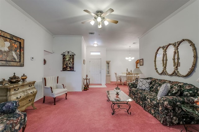 living room featuring ceiling fan with notable chandelier, ornamental molding, and carpet floors