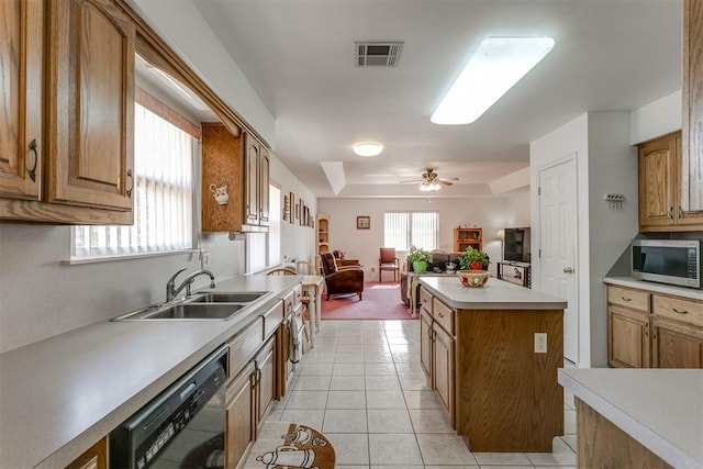 kitchen with ceiling fan, dishwasher, sink, light tile patterned flooring, and a kitchen island