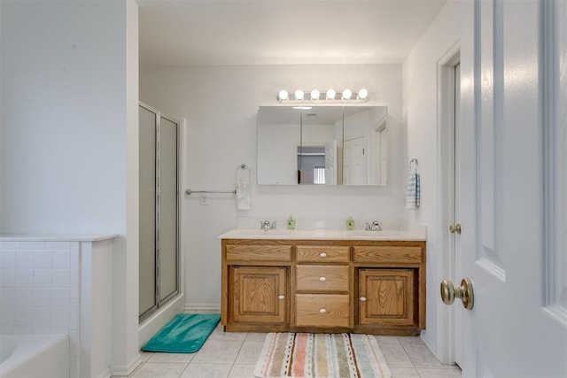 bathroom with tile patterned floors, vanity, and shower with separate bathtub