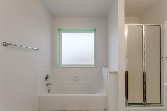 bathroom featuring separate shower and tub