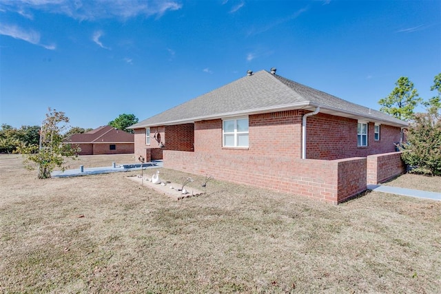 rear view of property featuring a lawn